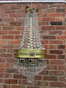 AN EARLY 20TH CENTURY BRASS-FRAMED ART DECO STYLE EMPIRE CRYSTAL CHANDELIER, approx. overall H 85