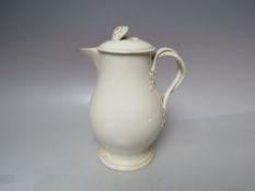 AN 18TH CENTURY WEDGWOOD CREAMWARE JUG AND COVER, unmarked example, H 19 cm