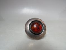 A CIRCULAR NIELS ERIK FROM DANISH MODERNIST SILVER BROOCH, set with central amber coloured cabochon,