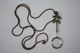 A 925 STAMPED ARTICULATED SILVER TEDDY BEAR MOUNTED EYE GLASS, L 9 cm, on unrelated base metal