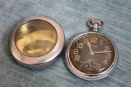 A WALTHAM OPEN FACED MANUAL WIND MILITARY POCKET WATCH, Dia 5 cm, together with a steel protective