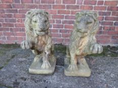 A PAIR OF CAST STONE LION GARDEN FIGURES, with raised paw, bearing makers stamp to base, H 62 cm, D
