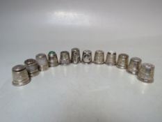 A COLLECTION OF TWELVE HALLMARKED SILVER THIMBLES, various dates and makers, to include two examples