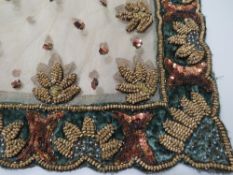 A HEAVILY EMBELLISHED DECORATIVE TABLE COVER, scalloped edge to velvet border with profuse sequinned