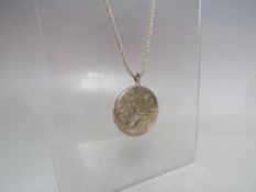 A HALLMARKED SILVER LARGE CIRCULAR LOCKET, locket Dia. 4.3 cm, suspended on a silver chain, combined