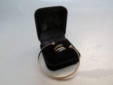 A HALLMARKED 9CT GOLD BANGLE, approx. 8.1 g, together with a modern gemset ring, size N, approx 1.