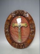 A CASED CRUCIFIX WITH WHITE METAL STUDY OF CHRIST WITHIN A DOMED GLAZED FRAME, approximately 38 x