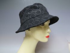 AN MCQ ALEXANDER McQUEEN BUCKET HAT IN BLACK, multiplied logo design 100% cotton canvasCondition