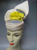 A HANDCRAFTED FASCINATOR BY K J MILLINERY, natural hessian style fabric with silver beading and