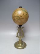 A DESK GLOBE ON LYRE BASE, H 31.5 cm