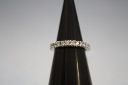AN 18 CARAT WHITE GOLD FULL ETERNITY DIAMOND RING, set with an estimated 1 carat of brilliant cut