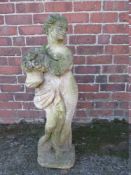A STONE GARDEN 'SPRING' FIGURE, depicting a lady holding a basket of flowers, H 87.5 cm