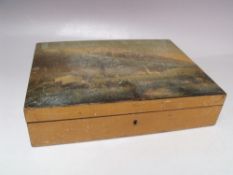 A 20TH CENTURY LIDDED WOODEN BOX, the lid with painting of an Alpine village scene, the interior