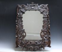 CIRCA 16TH CENTURY. Profusely carved oak frame with later silvered mirror plate, width of frame 12