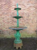 A CAST IRON THREE TIER FOUNTAIN, raised on a plinth decorated with three heron type birds, overall H