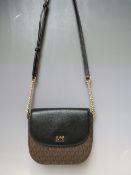 A MICHAEL KORS CROSS BODY BAG, brown logo design, black front panel with gilt logo and magnetic