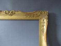 A LATE 19TH / EARLY 20TH CENTURY GOLD SWEPT FRAME, frame W 8 cm, frame rebate 68.5 x 52.5 cm