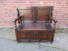 A VINTAGE OAK MONKS BENCH, with linen fold front, W 119 cm