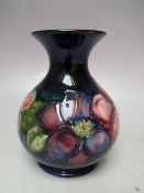 A MOORCROFT CLEMATIS PATTERN SQUAT VASE, with flared rim, typical tubelined decoration, impressed