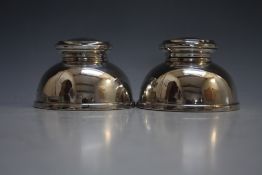 A PAIR OF UNUSUAL DOME SHAPED CAPSTAN TYPE HALLMARKED SILVER INKWELLS - BIRMINGHAM 1949, with