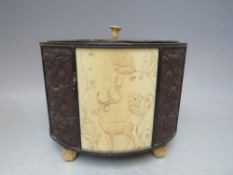 AN ANTIQUE CARVED IVORY AND EBONISED OVAL CONTAINER WITH LID, the separate lid with carved ivory