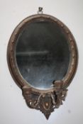 A 20TH CENTURY GILT OVAL MIRROR WITH TWIN CANDLE SCONCE, with carved detail, H 65 cm