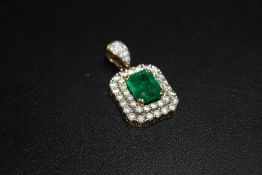 AN EMERALD AND DIAMOND ART DECO PENDANT, set with a central emerald cut emerald of an estimated 3.