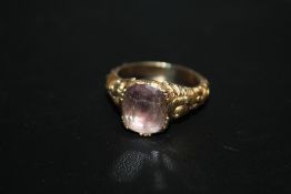 AN ANTIQUE GEORGIAN STYLE RING, set with an amethyst type stone and engraved inside the unmarked