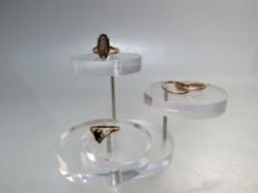 THREE 9CT GOLD LADIES DRESS RINGS, comprising smokey quartz set ring - size M, a wishbone ring -