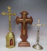 THREE EARLY TO MID 20TH CENTURY FREE STANDING / ALTAR CRUCIFIX, comprising a tall brass example, H