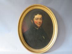 (XIX). An oval portrait study of a gentleman wearing a black coat and sporting large sideburns,