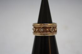 AN UNUSUAL WIDE BAND 9 CARAT GOLD DIAMOND SET RING, approx weight 7.4g, ring size K