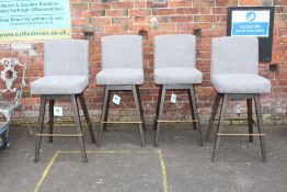 A SET OF FOUR MODERN UPHOLSTERED SWIVEL BAR STOOLS