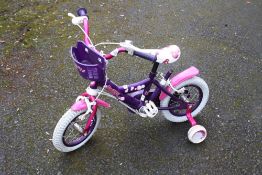 A SMALL CHILDS PURPLE BICYCLE