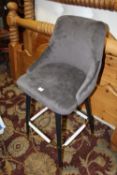 A MODERN UPHOLSTERED BAR STOOL