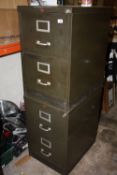 A PAIR OF TWO DRAWER METAL FILING CABINETS