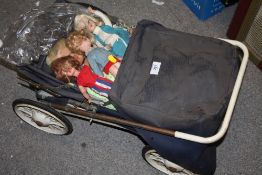 A VINTAGE DOLLS PRAM CONTAINING DOLLS