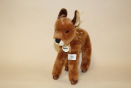 A STEIFF DEER SOFT TOY WITH LABEL IN EAR