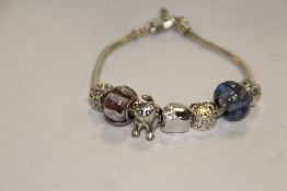A MODERN STERLING SILVER CHARM BRACELET WITH ASSORTED CHARMS APPROX WEIGHT - 27.3G