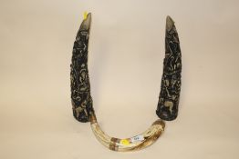 A PAIR OF MODERN RESIN TUSK SHAPED ORNAMENTS TOGETHER WITH A VINTAGE METAL BANDED EXAMPLE