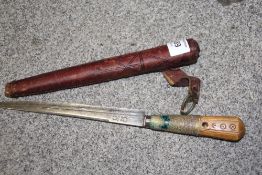 AN EASTERN STYLE DAGGER IN LEATHER SHEATH