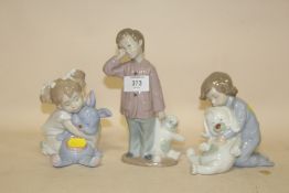 THREE NAO FIGURES OF CHILDREN WITH SOFT TOYS