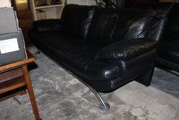 A BLACK LEATHER TWO PIECE SUITE RAISE ON CHROME EFFECT SEAT COMPRISING 2 & 3 SEATER SETTEES