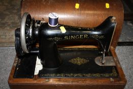 AN OAK CASED VINTAGE SINGER SEWING MACHINE