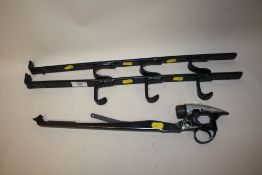 A PAIR OF WALL MOUNTABLE GUN RACKS, TOGETHER WITH AN AIR RIFLE TRIGGER MECHANISM