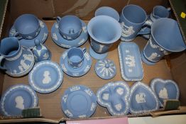 A TRAY OF BLUE WEDGWOOD JASPERWARE TO INCLUDE A TRUMPET VASE, CUPS AND SAUCERS ETC.