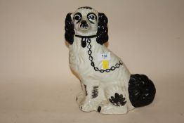 A STAFFORDSHIRE STYLE CERAMIC SPANIEL FIGURE