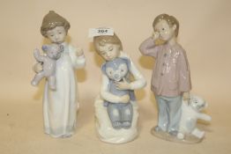 THREE NAO FIGURES OF YOUNG BOYS WITH TEDDY BEARS