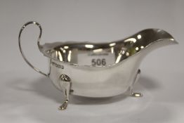 A HALLMARKED SILVER SAUCE BOAT