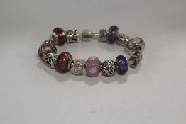 A MODERN STERLING SILVER CHARM BRACELET WITH ASSORTED CHARMS APPROX WEIGHT - 57.6G